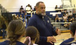 Marco Altieri, a girls' volleyball coach, addressing a group of girls.