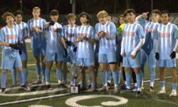 A group of boys soccer players posing for a picture at the Staten Island High School All-Star Game.