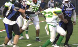 A group of people playing football in the PSAL championship game during the grid season at Springfield Gardens.