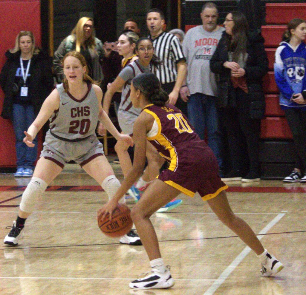 A girl is dribbling a basketball during the first round of the Borough President's Cup.