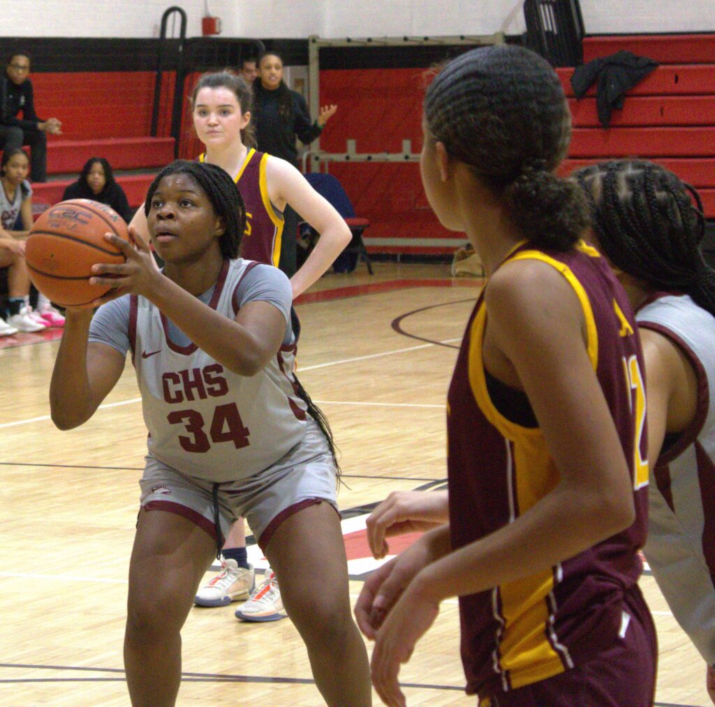 Curtis S.I. Academy girls' basketball team playing on a court.