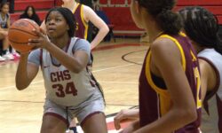 Curtis S.I. Academy girls' basketball team playing on a court.