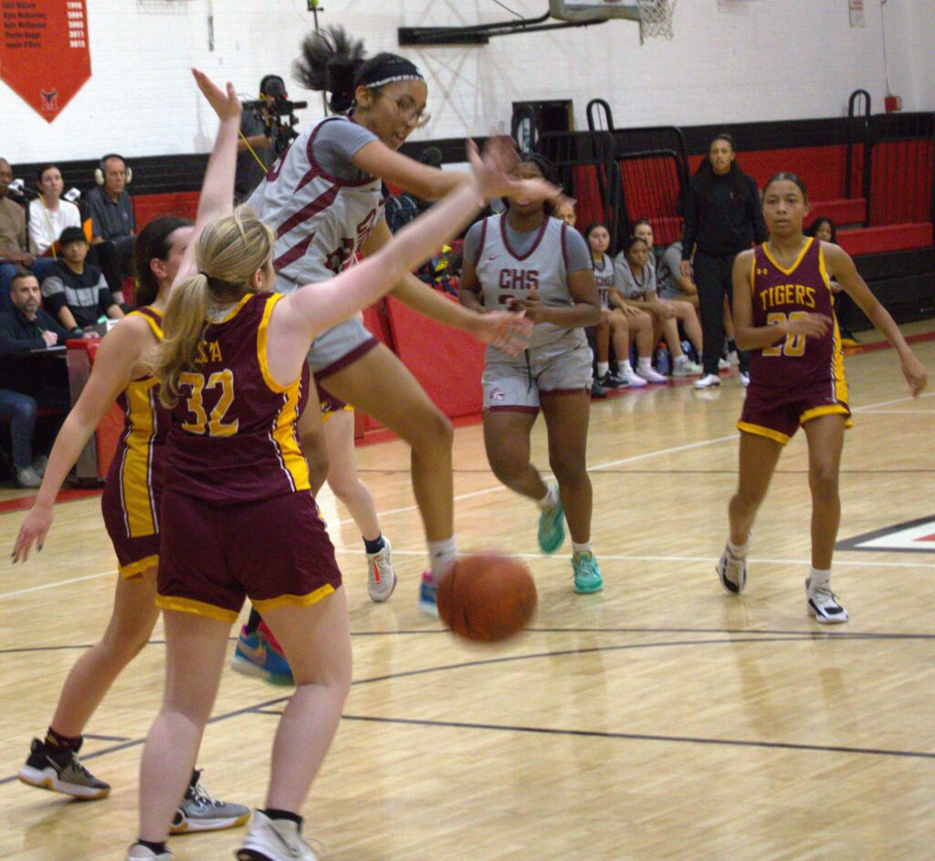 A group of girls competing in the first round of the Borough President's Cup, playing basketball on a court.