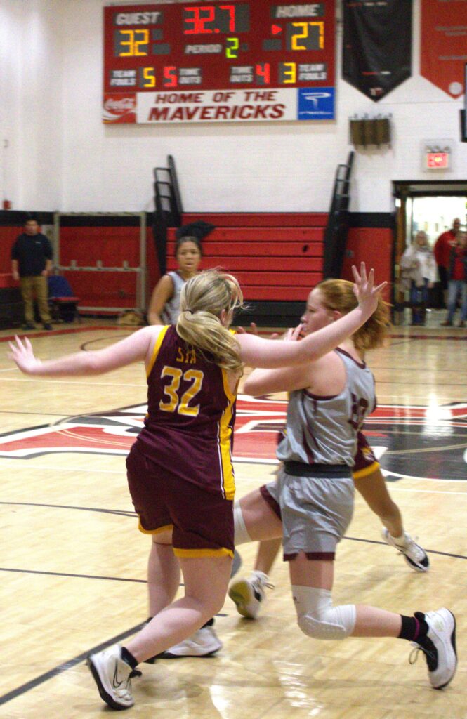 A group of girls competing in the first round of the Borough President's Cup basketball tournament on a court.