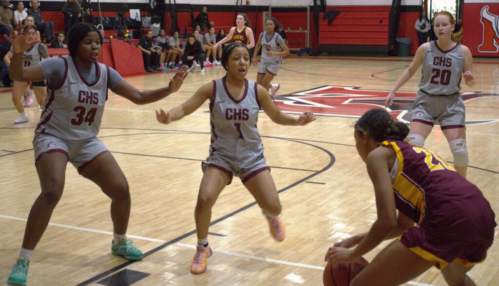 A group of girls from S.I. Academy playing basketball on the Curtis court.