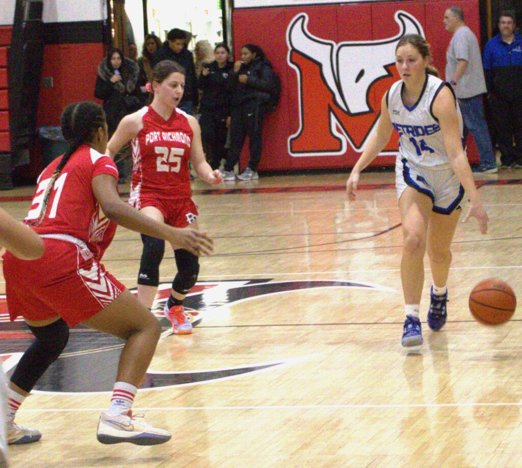 A group of girls participating in the first round of the Borough President's Cup basketball tournament on a court.