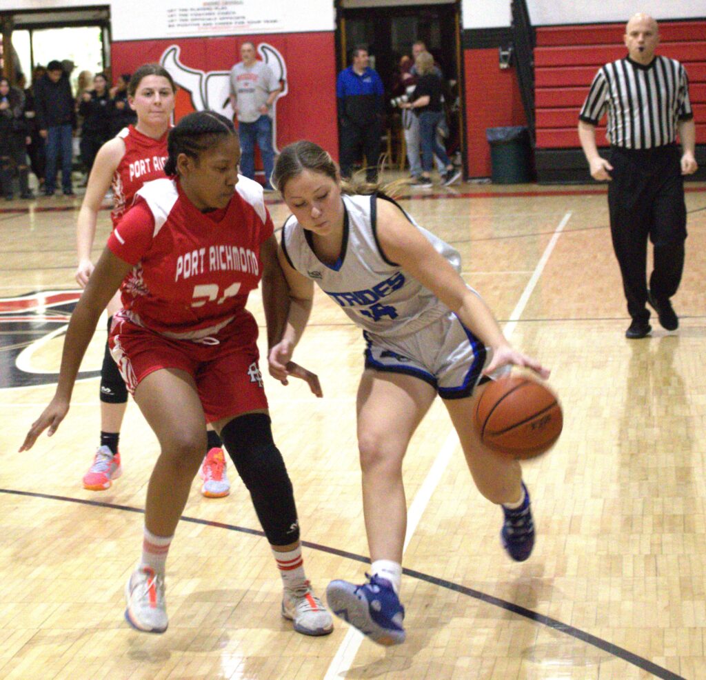 Two girls competing in the first round of Borough President's Cup, playing basketball on a court.