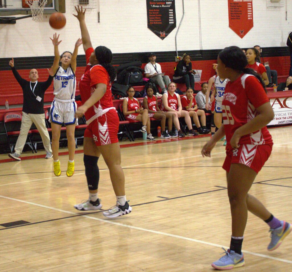 A group of girls competing in the first round of the Borough President's Cup basketball tournament on a court.