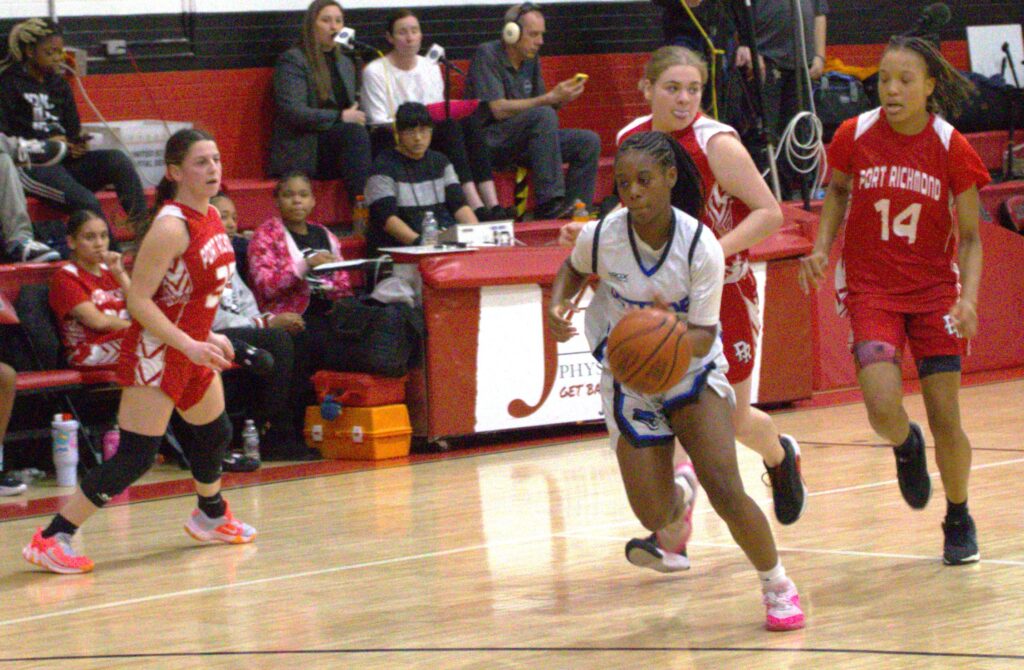 A group of girls participating in the first round of the Borough President's Cup basketball tournament on a court.