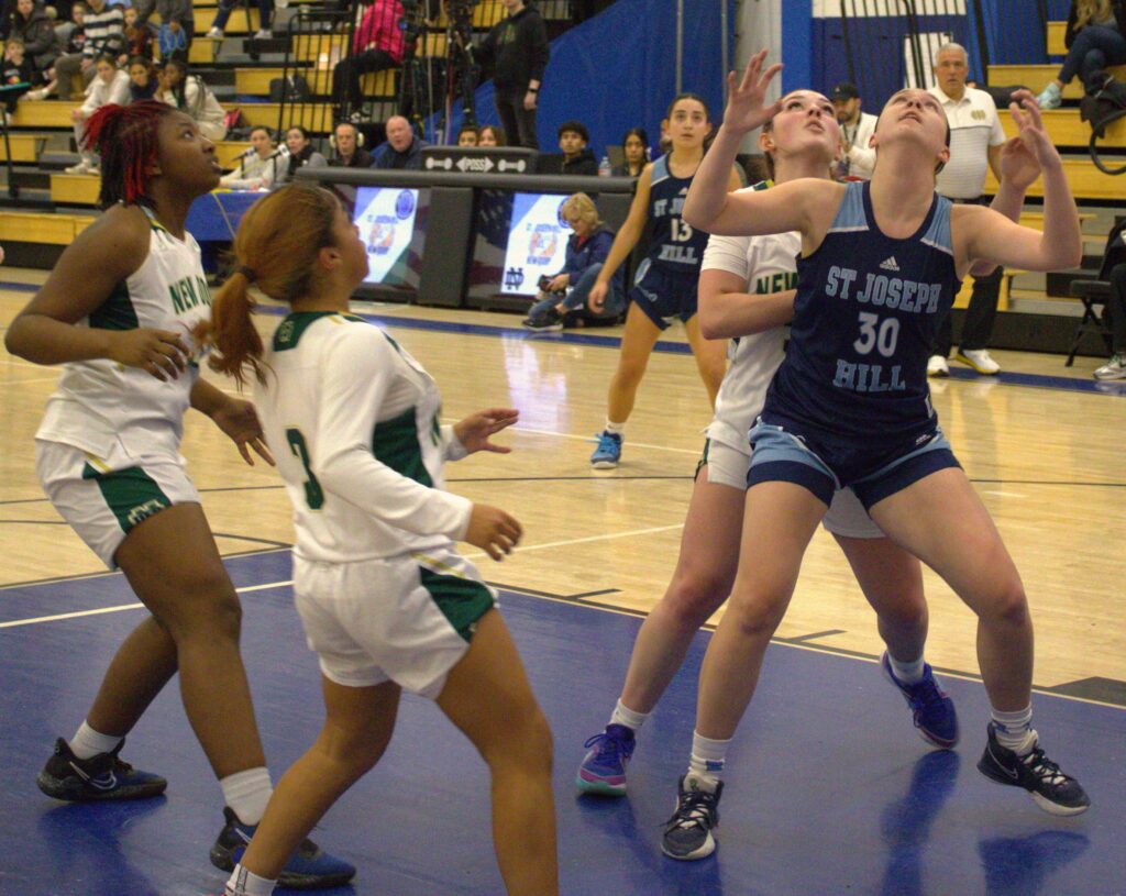 A group of women playing basketball at S.I. High School.