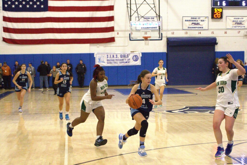 A group of high school girls playing basketball in the Hill borough during the Sea championship.