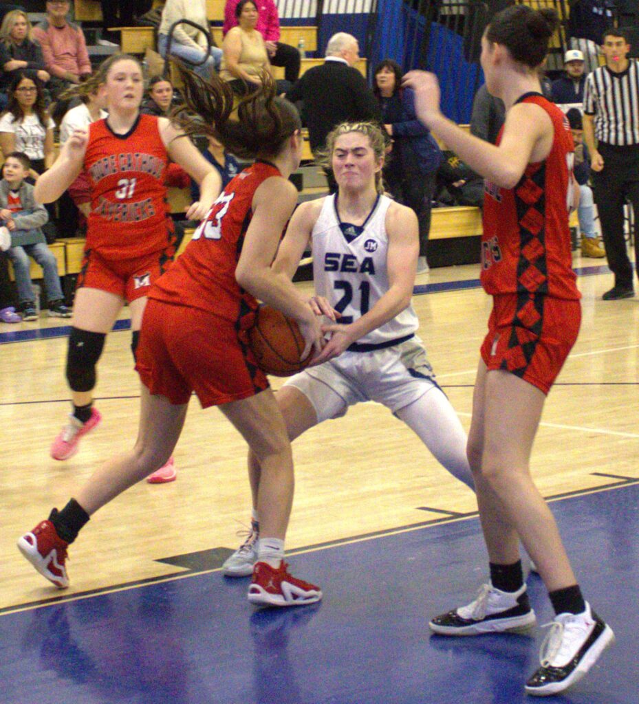 A group of girls playing basketball at S.I. High School in the Borough President's Tournament.