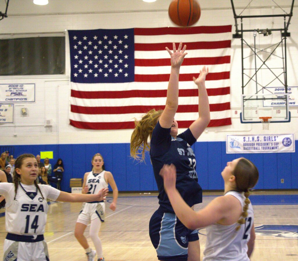 A group of girls participating in the Borough President's Cup Tournament and playing basketball.