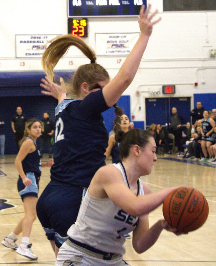 ***A group of girls playing basketball in the Borough President's Cup Tournament by the sea.***