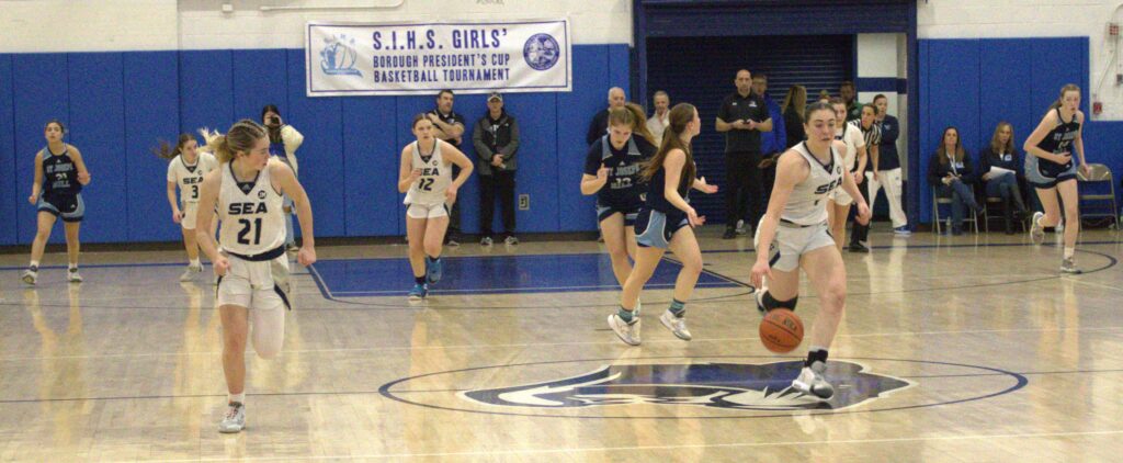 A group of girls playing basketball at the Borough President's Cup tournament.