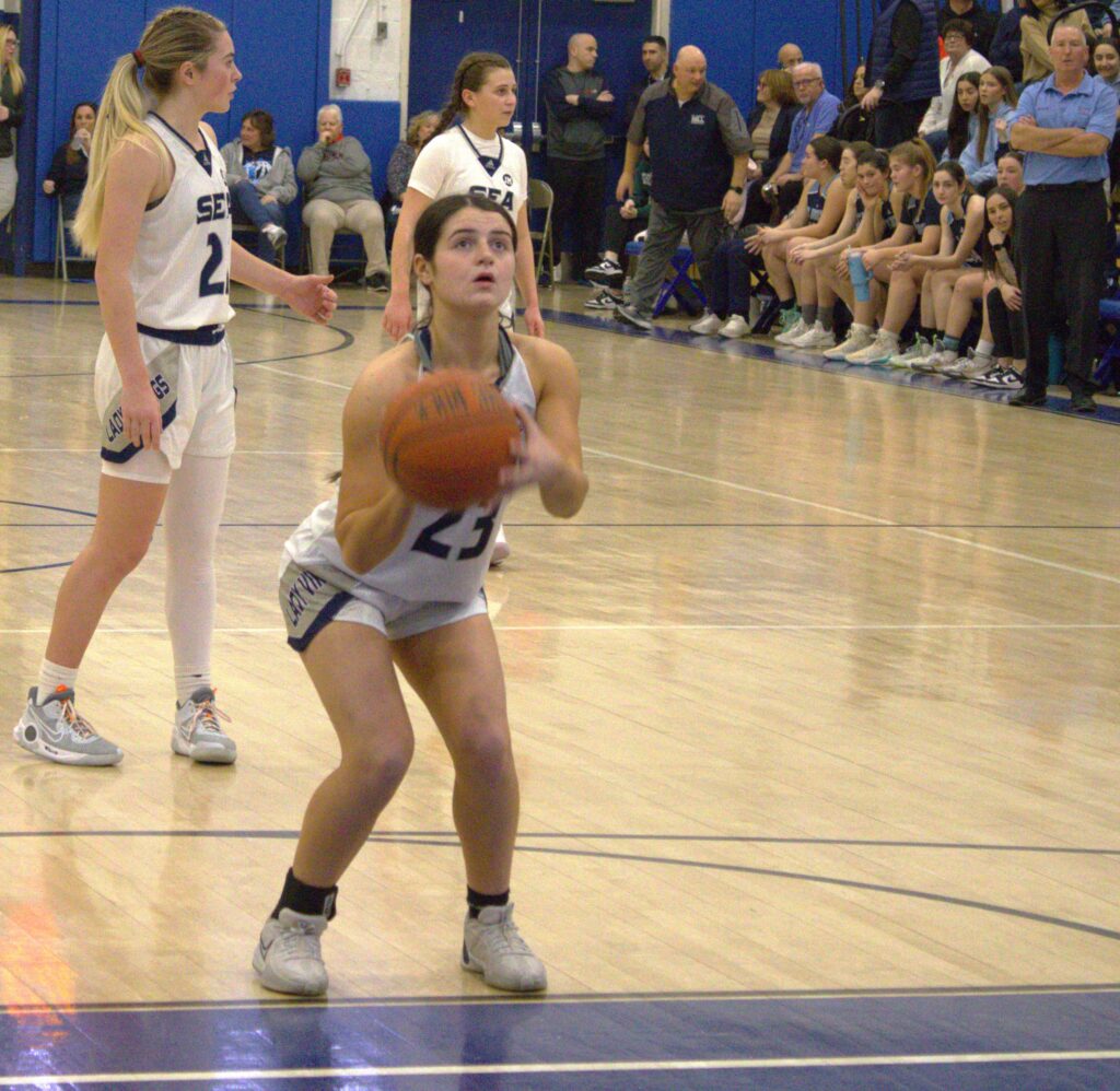 A woman participating in the Borough President's Cup Tournament, showcasing her basketball skills in a gym.