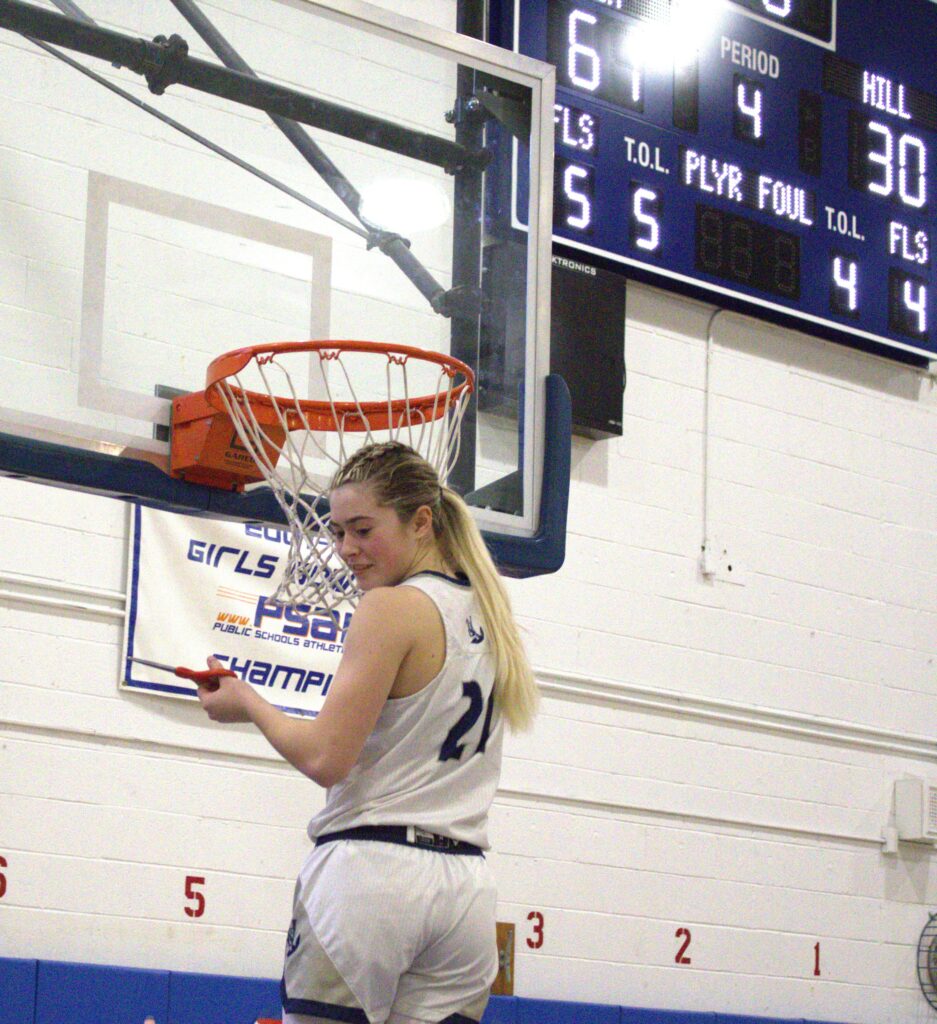 A woman sea in a basketball uniform participates in a tournament.