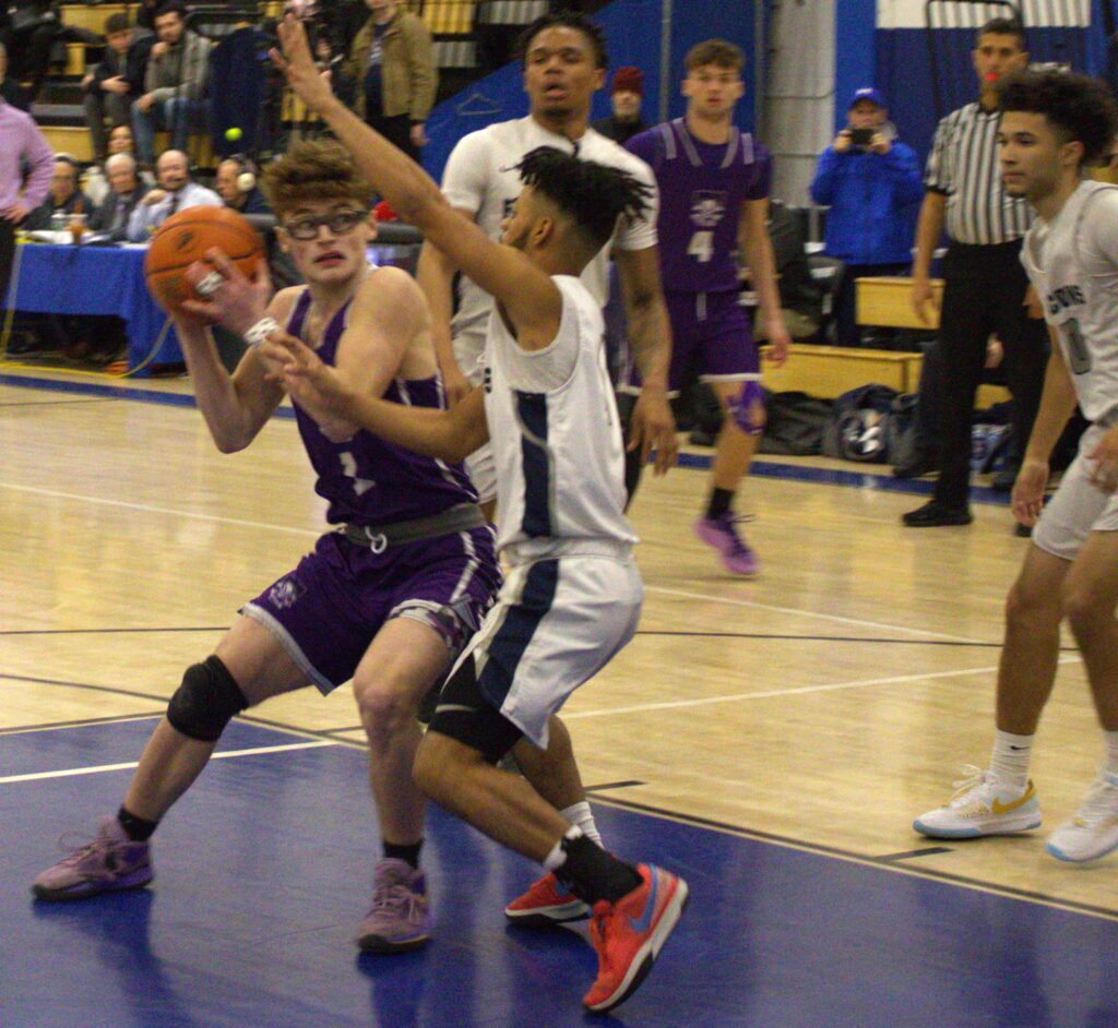 A group of people playing basketball in the SIHSL Tournament championship.