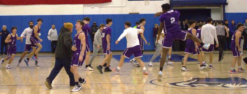 A group of boys from St. Peters and Tottenville playing basketball in a gym during the SIHSL Tournament.