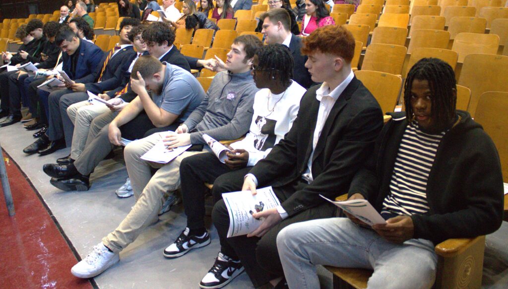 A group of winners sitting in an auditorium.