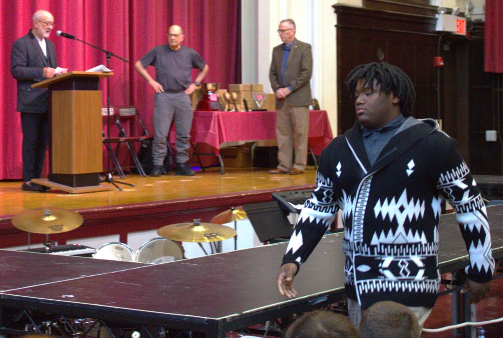 A man stands in front of a ping pong table.