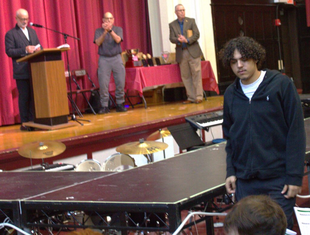 A man stands in front of a ping pong table.