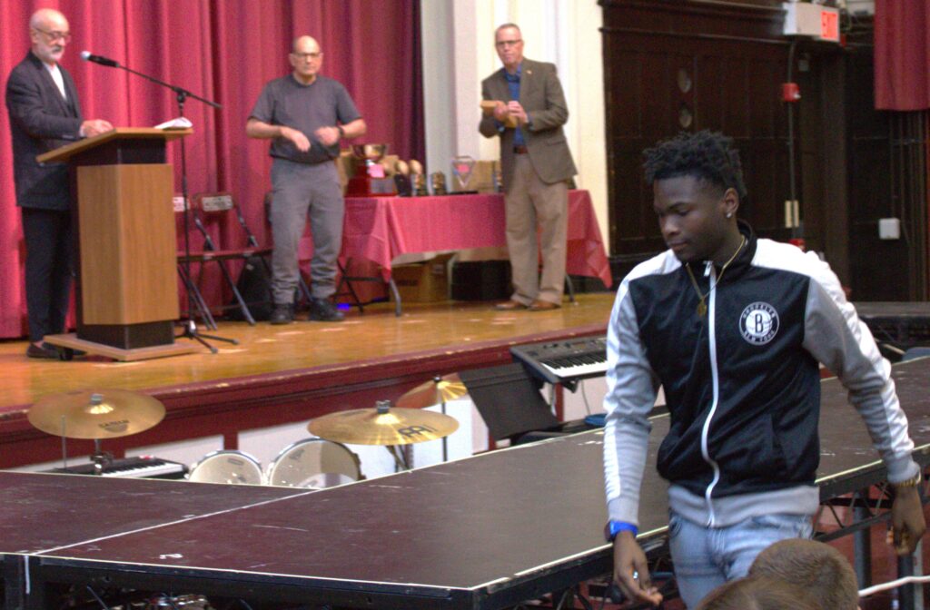 A man standing on a ping pong table.