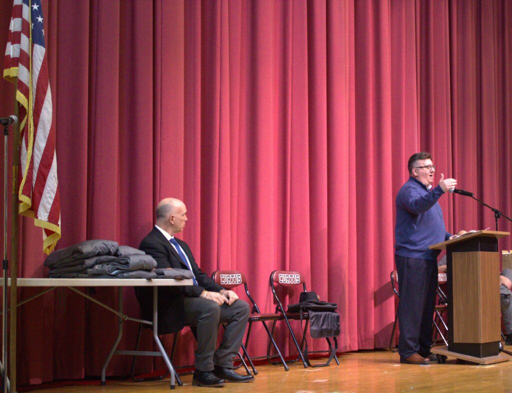 A man giving a speech at a podium.