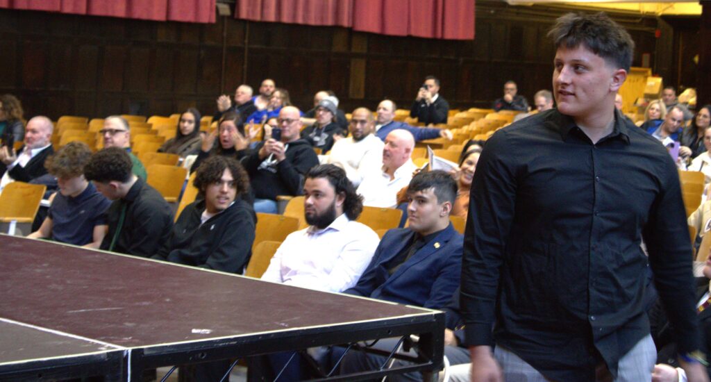 A man standing in front of a crowd of people at an awards ceremony.