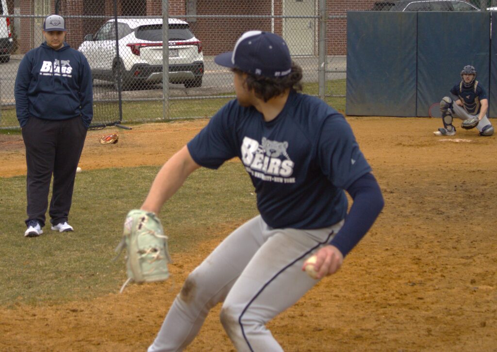 A baseball player from St. Joseph's University throwing a ball.